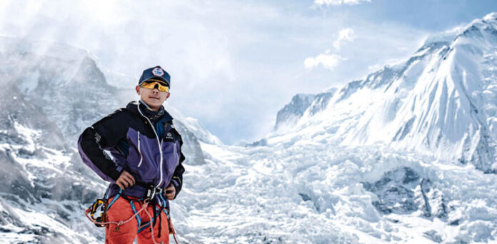 Nima Rinji Sherpa celebrates at the summit of Mount Shishapangma